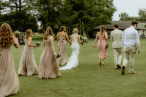a group of people walking on grass